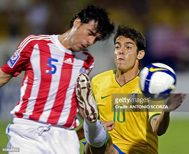 Brazilian footballer Kaka fails to stop a header by Paraguay's Julio Cesar Caceres during their FIFA World Cup South Africa 2010 qualifier football...