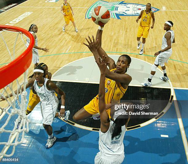 Lisa Leslie of the Los Angeles Sparks takes a shot while blocked by LaToya Pringle of the Minnesota Lynx at the Target Center June 10, 2009 in...