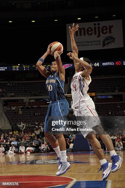 Alana Beard of the Washington Mystics attempts a shot against Deanna Nolan of the Detroit Shock on June 10, 2009 at The Palace of Auburn Hills in...