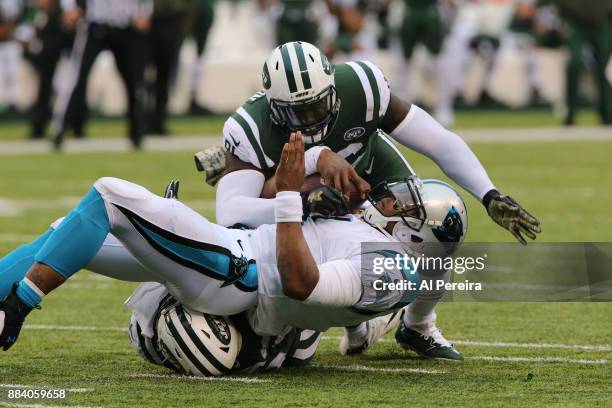 Linebacker DeMario Davis and Defensive Lineman Muhammad WIlkerson of the New York Jets make a stop against the Carolina Panthers during their game at...