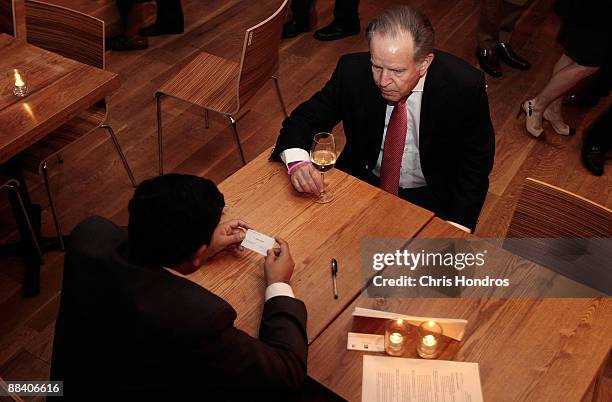 Job seeker watches while a recruiter looks over his card during a Wall Street Pink Slip Party at City Winery June 10, 2009 in New York City. The...