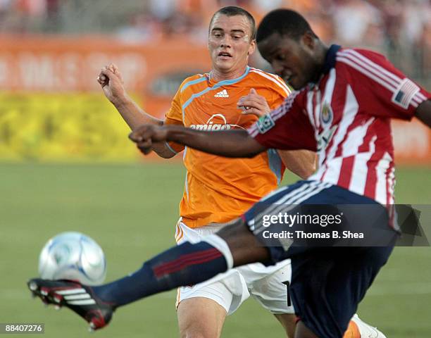 Cam Weaver of the Houston Dynamo defends against Shaver Thomas of Chivas USA at Robertson Stadium on June 10, 2009 in Houston, Texas.