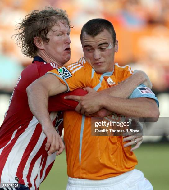 Cam Weaver of the Houston Dynamo heads the ball over Jim Curtin of Chivas USA at Robertson Stadium on June 10, 2009 in Houston, Texas.