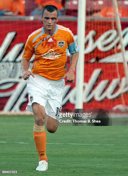 Cam Weaver of the Houston Dynamo runs off the field to change his bloody shirt while playing against Chivas USA at Robertson Stadium on June 10, 2009...