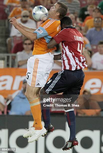 Cam Weaver of the Houston Dynamo heads the ball over Shaver Thomas of Chivas USA at Robertson Stadium on June 10, 2009 in Houston, Texas.