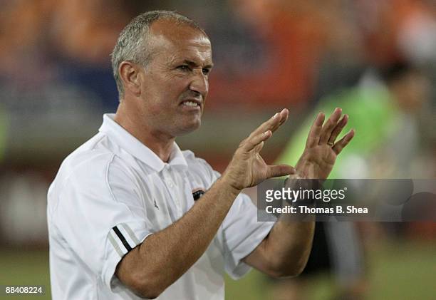 Head coach Dominic Kinnear of the Houston Dynamo gives directions to his players while the Dynamo play against Chivas USA at Robertson Stadium on...