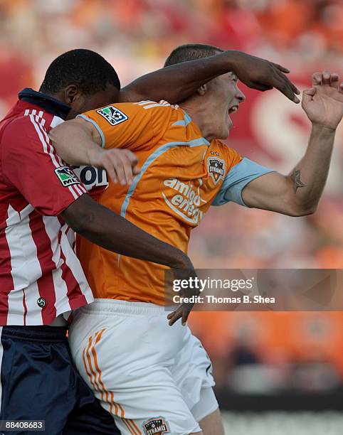 Cam Weaver of the Houston Dynamo heads the ball over Shaver Thomas of Chivas USA at Robertson Stadium on June 10, 2009 in Houston, Texas.