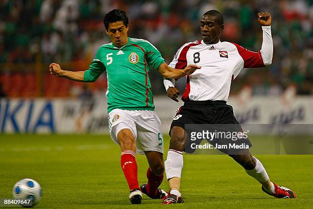 Mexico's Ricardo Osorio vies for the ball with Trindad & Tobago's Noel Trent during their 2010 FIFA World Cup qualifier at the Azteca Stadium on June...