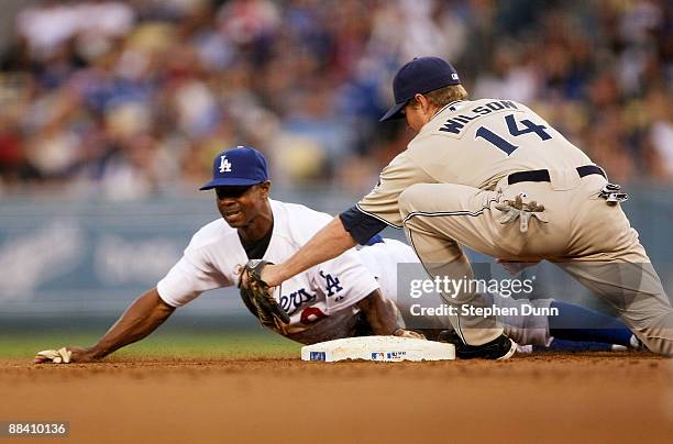 Juan Pierre of the Los Angeles Dodgers slides into second with a stoloen base ahead of the tag of shortstop Josh Wilson of the San Diego Padres in...