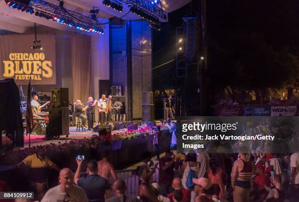 View across the audience at the Petrillo Music Shell stage as they watch American Funk and Soul band Fred Wesley and the New JBs perform during the...