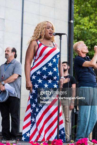 In a dress modelled after the American flag, American Blues and Soul singer Nellie Tiger Travis performs the National Anthem to open the evening's...