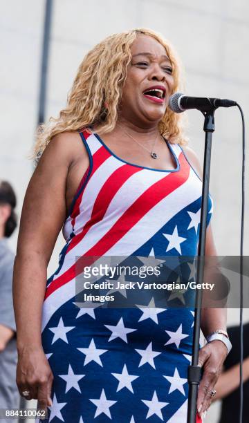 In a dress modelled after the American flag, American Blues and Soul singer Nellie Tiger Travis performs the National Anthem to open the evening's...