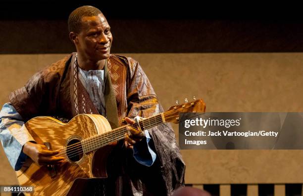 Malian Songhai musician Sidi Toure plays guitar with his trio at Lincoln Center's David Rubinstein Atrium, New York, New York, October 13, 2011. The...