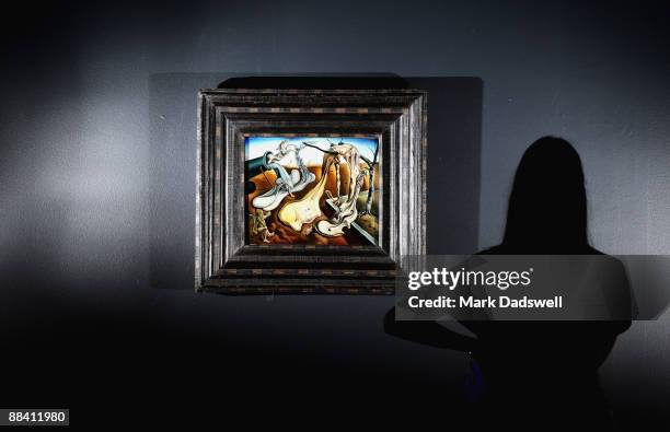 Gallery staff members studies the oil on canvas work "Daddy Longlegs of the Evening - Hope!" ahead of Saturday's public opening of the 'Liquid...