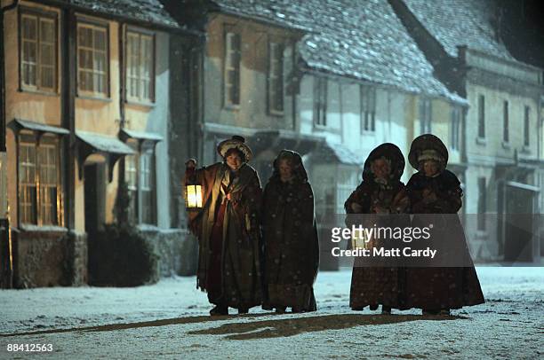 Actors including Dame Judi Dench, and Imelda Staunton walk down Lacock High Street, which has been transformed for a night shoot of the BBC period...