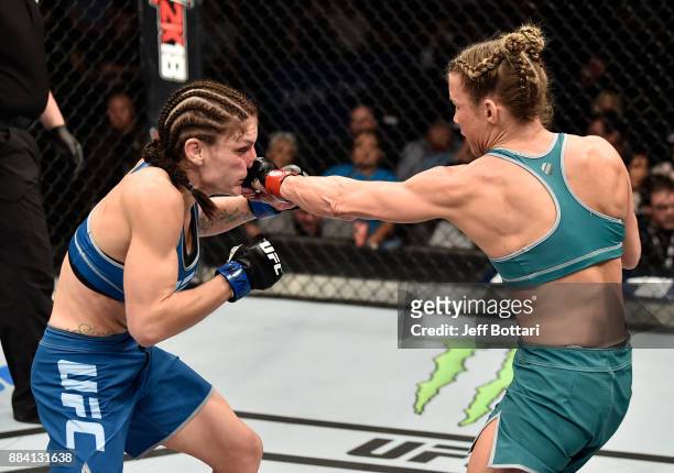 Barb Honchak punches Lauren Murphy in their women's flyweight bout during the TUF Finale event inside Park Theater on December 01, 2017 in Las Vegas,...