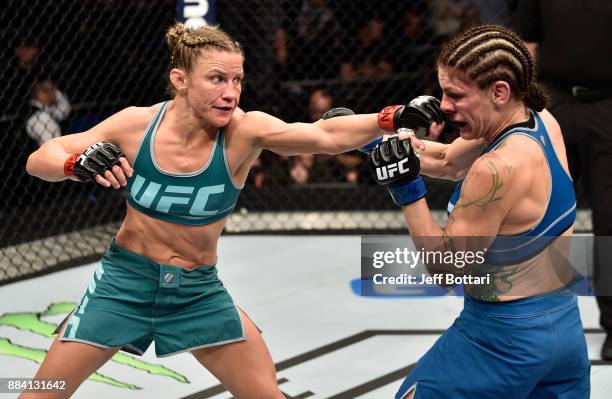 Barb Honchak punches Lauren Murphy in their women's flyweight bout during the TUF Finale event inside Park Theater on December 01, 2017 in Las Vegas,...