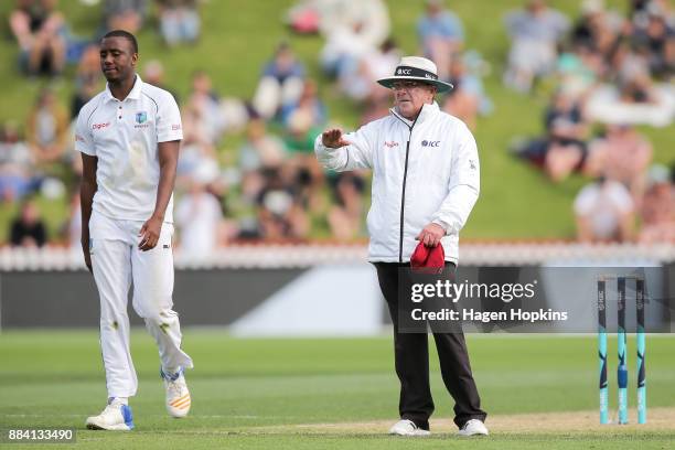 Umpire Ian Gould of England signals a boundary while Miguel Cummins of the West Indies looks on during day two of the Test match series between New...