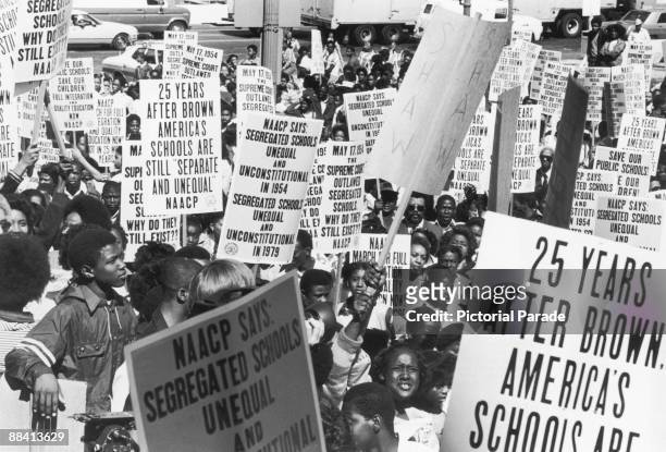 Schoolchildren and members of the NAACP parade in Washington DC, 17th May 1979, the 25th anniversary of the US Supreme Court's ruling, which ended...