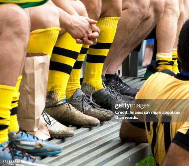 detail of soccer players legs after a difficult match. - mannschaftsfußball stock-fotos und bilder