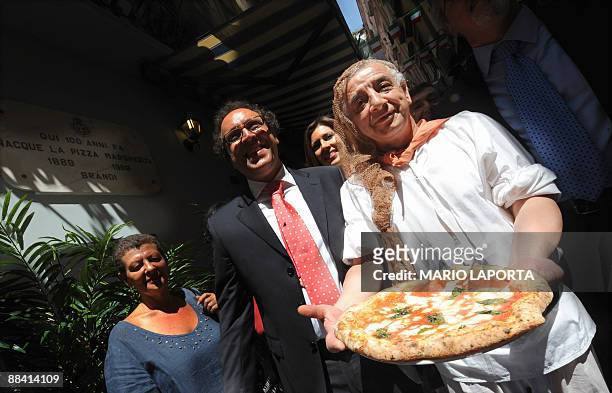 Pizzaiolo of the Brandi restaurant holds a pizza named after Queen Margherita of Savoy during a ceremony to celebrate the 120th anniversary of the...