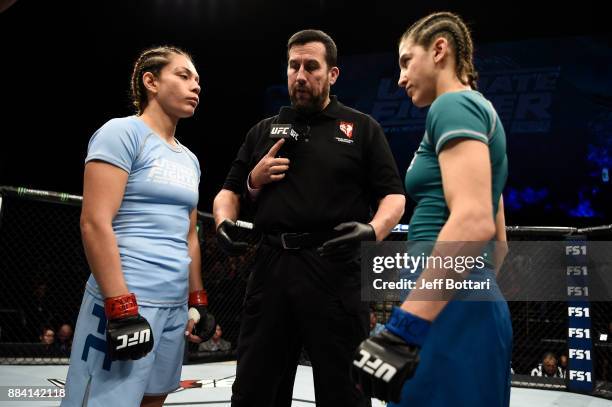 Opponents Nicco Montano and Roxanne Modafferi receive instructions from referee John McCarthy prior to their women's flyweight championship bout...