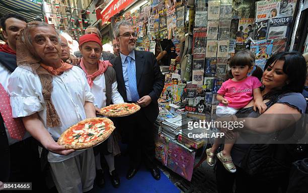 Pizzaiolos of the Brandi restaurant hold pizzaS named after Queen Margherita of Savoy during a ceremony to celebrate the 120th anniversary of the...