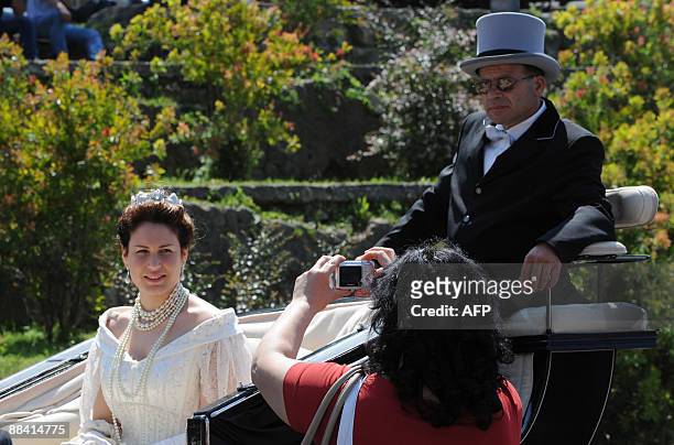 An actress dressed like Queen Margherita of Savoy arrives in a horse coach for a ceremony to celebrate the 120th anniversary of the pizza Margherita...