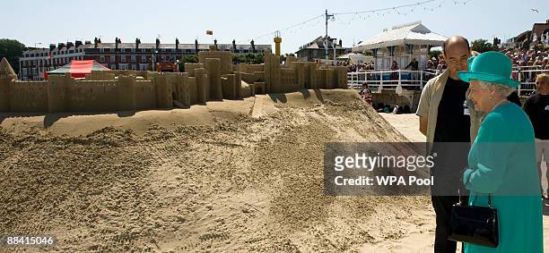 Queen Elizabeth II looks at the recreation of Windsor Castle made entirely of sand during her visit to Weymouth on June 11, 2009 in Weymouth, England.