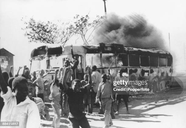 Young rioters surround a burning bus during the Soweto Uprising in Johannesburg, 17th June 1976. The riots were a reaction against the government's...