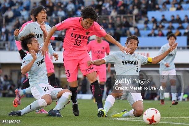 Mu Kanazaki of Kashima Antlers controls the ball under pressure of Daiki Ogawa and Kentaro Oi of Jubilo Iwata during the J.League J1 match between...