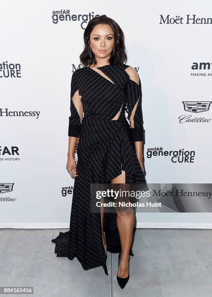 Kat Graham attends the 2017 amfAR generationCURE Holiday Party on December 1, 2017 in New York City.