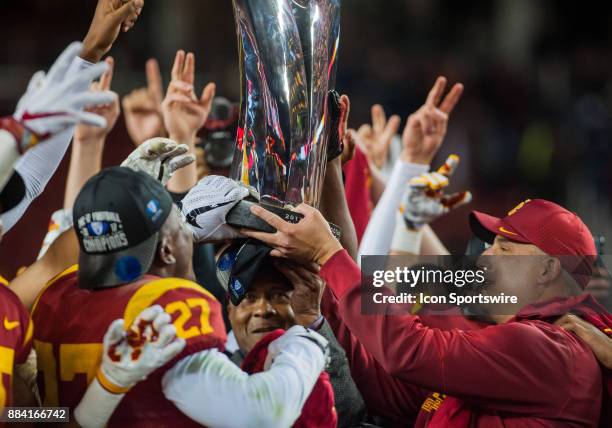 Trojans players and Head Coach Clay Helton lift up the conference trophy after winning 31-27 in the Pac-12 Championship game between the Stanford...