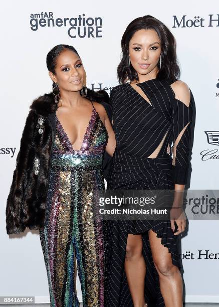 Aisha Reed and Kat Graham attends the 2017 amfAR generationCURE Holiday Party on December 1, 2017 in New York City.