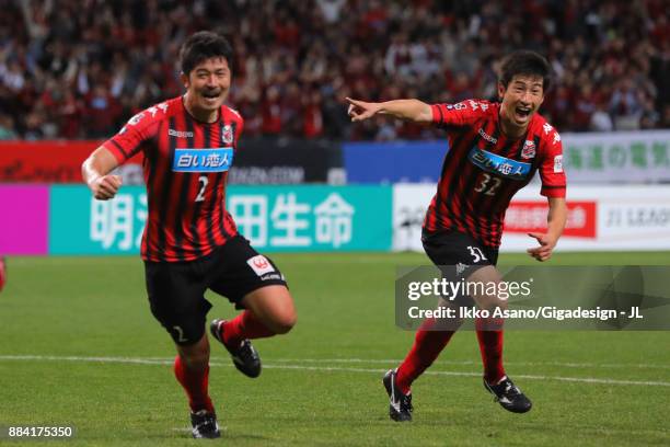 Tomonobu Yokoyama of Consadole Sapporo celebrates scoring his side's third goal with his team mate Naoki Ishikawa during the J.League J1 match...