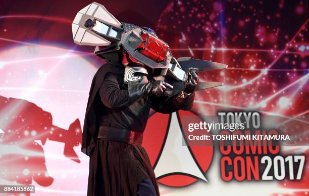 Star Wars fan wearing character Kylo Ren's TIE Silencer costume performs during the Star Wars Cosplay Showcase 2017, part of Tokyo Comic Con 2017 at...