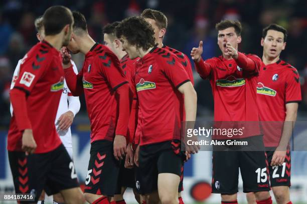 Pascal Stenzel of Freiburg directs the wall before a free-kick during the Bundesliga match between Sport-Club Freiburg and Hamburger SV at...