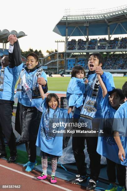 Yu Kobayashi and Kengo Nakamura of Kawasaki Frontale celebrate their J.League Champions with their children after the J.League J1 match between...