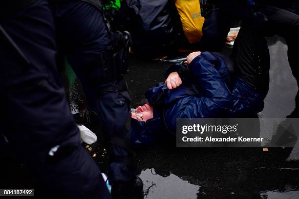 Left-wing protesters get sprayed by a water cannon as they clash with police forces outside the Hannover Congress Centrum prior to today's AfD...