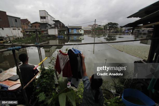 Girl is drying her clothes at Kapuk Teko village, Cengkareng regency of West Jakarta, Indonesia on November 30, 2017. The village is known as Kampung...