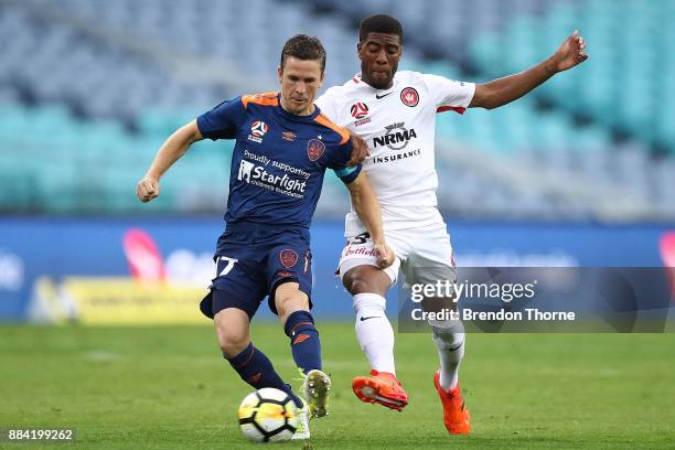 Matthew McKay of the Roar competes with Rolieny Bonevacia of the Wanderers during the round nine A-League match between the Western Sydney Wanderers...