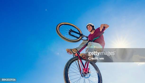 air bmx rider doing a trick - bmx freestyle stock pictures, royalty-free photos & images