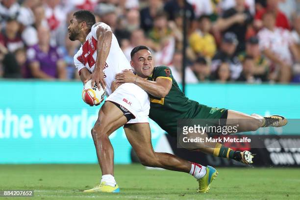 Kallum Watkins of England is tackled by Valentine Holmes of Australia during the 2017 Rugby League World Cup Final between the Australian Kangaroos...