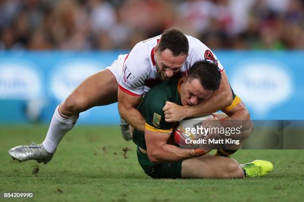 Cooper Cronk of the Kangaroos is tackled by Luke Gale of England during the 2017 Rugby League World Cup Final between the Australian Kangaroos and...