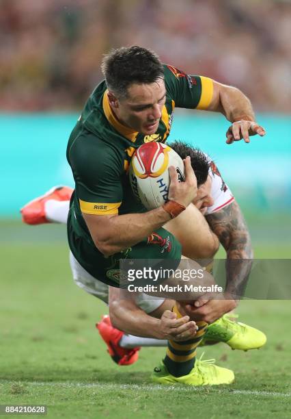 Cooper Cronk of Australia is tackled during the 2017 Rugby League World Cup Final between the Australian Kangaroos and England at Suncorp Stadium on...