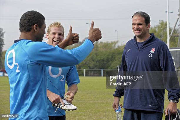 England's rugby national team full back Delon Armitage gives the thumbs up to head coach Martin Johnson who smiles next to o flanker James Haskell...