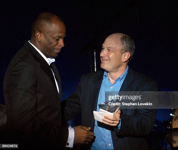 Singer Donnie McClurkin accepts his award from President/CEO of Zomba Label Group Barry Weiss during the Recording Academy New York Chapter's Tribute...