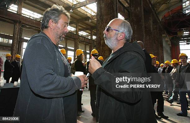 French director and producer Luc Besson speaks with French actor Gerard Jugnot during a press conference, on June 11, 2009 in Saint-Denis, outside...