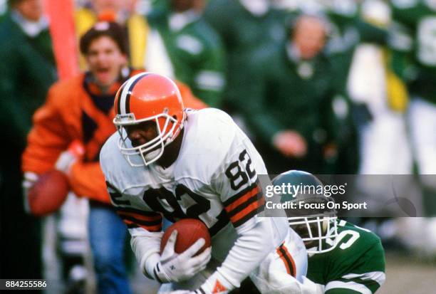 Tight End Ozzie Newsome of the Cleveland Browns gets dragged down from behind by Kevin McArthur of the New York Jets during an NFL football game...