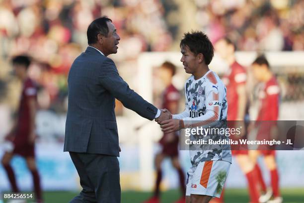 Head coach Shinji Kobayashi of Shimizu S-Pulse shakes hands with Shota Kaneko after their 3-1 victory and avoided the relegation to the J2 after the...